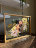 Angled oak Held in Bloom pressed flower frame featuring a colour wedding photo and preserved blush, yellow and green bouquet flowers.